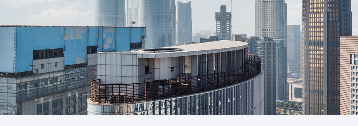 Modern building rooftop representing the Real Estate and Hospitality practice